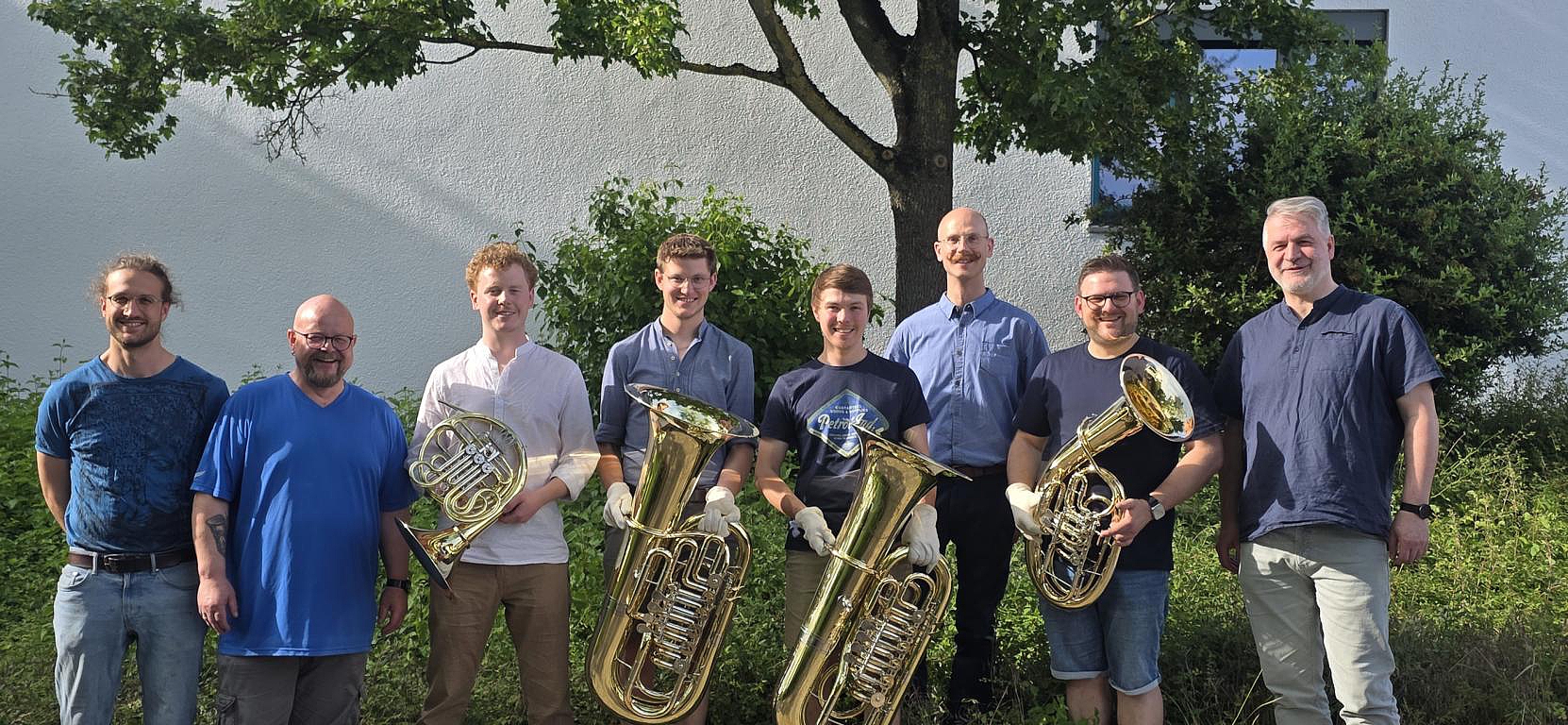 Absolventen und Lehrer des Meisterkurses im Metallblasinstrumentenbau mit ihren Prüfungsarbeiten vor der Oscar-Walcker-Schule.